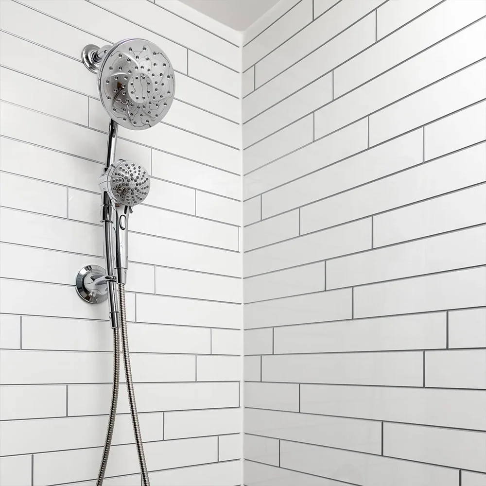 White subway-style shower wall pattern with chrome fixtures
