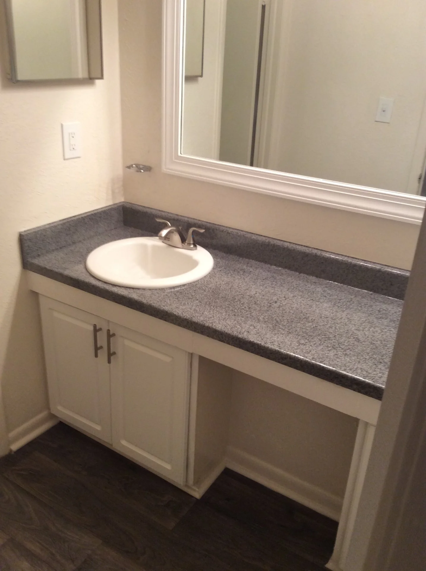 Single-sink apartment bathroom countertop after refinishing