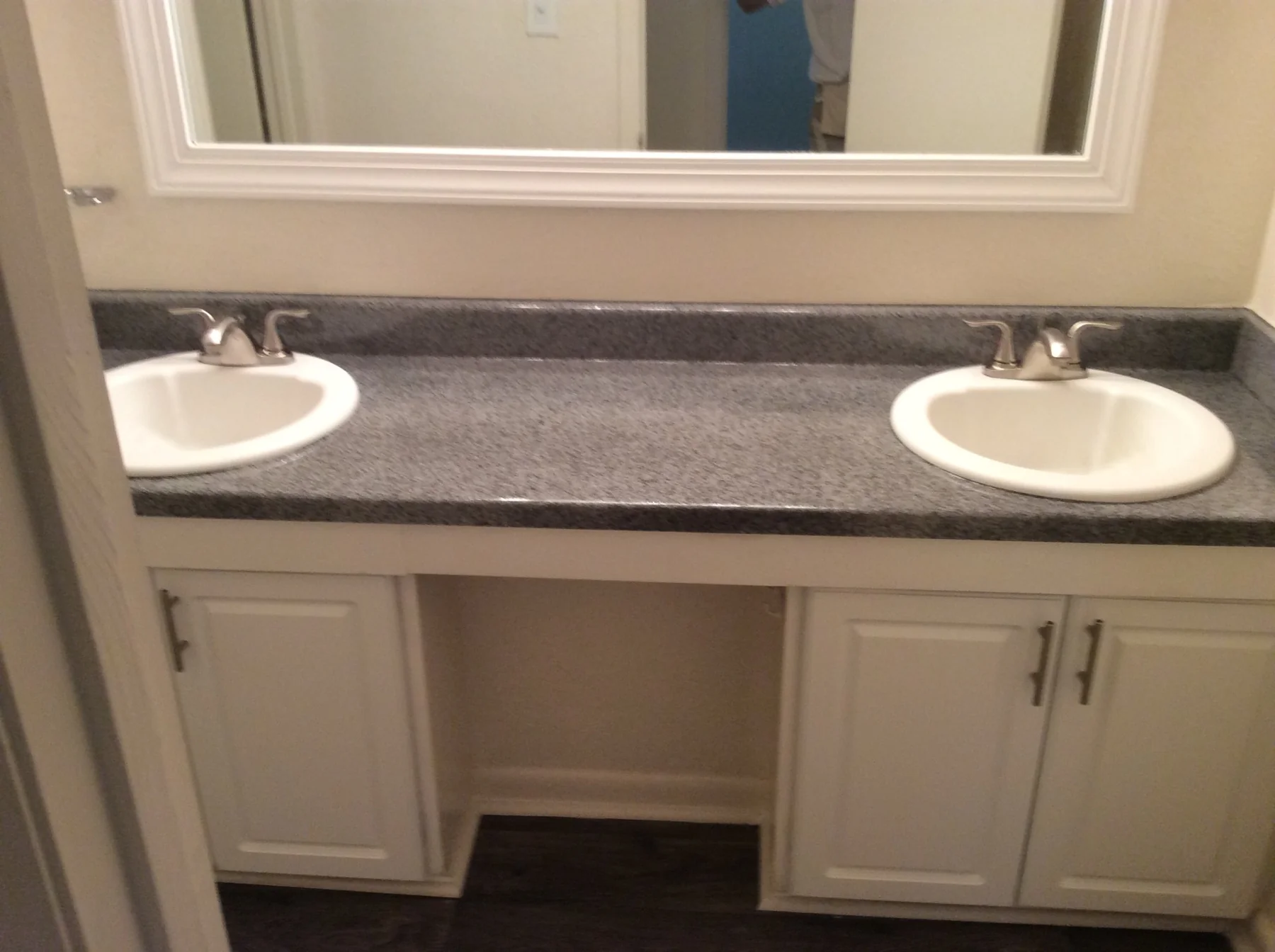Double-sink apartment bathroom countertop after refinishing