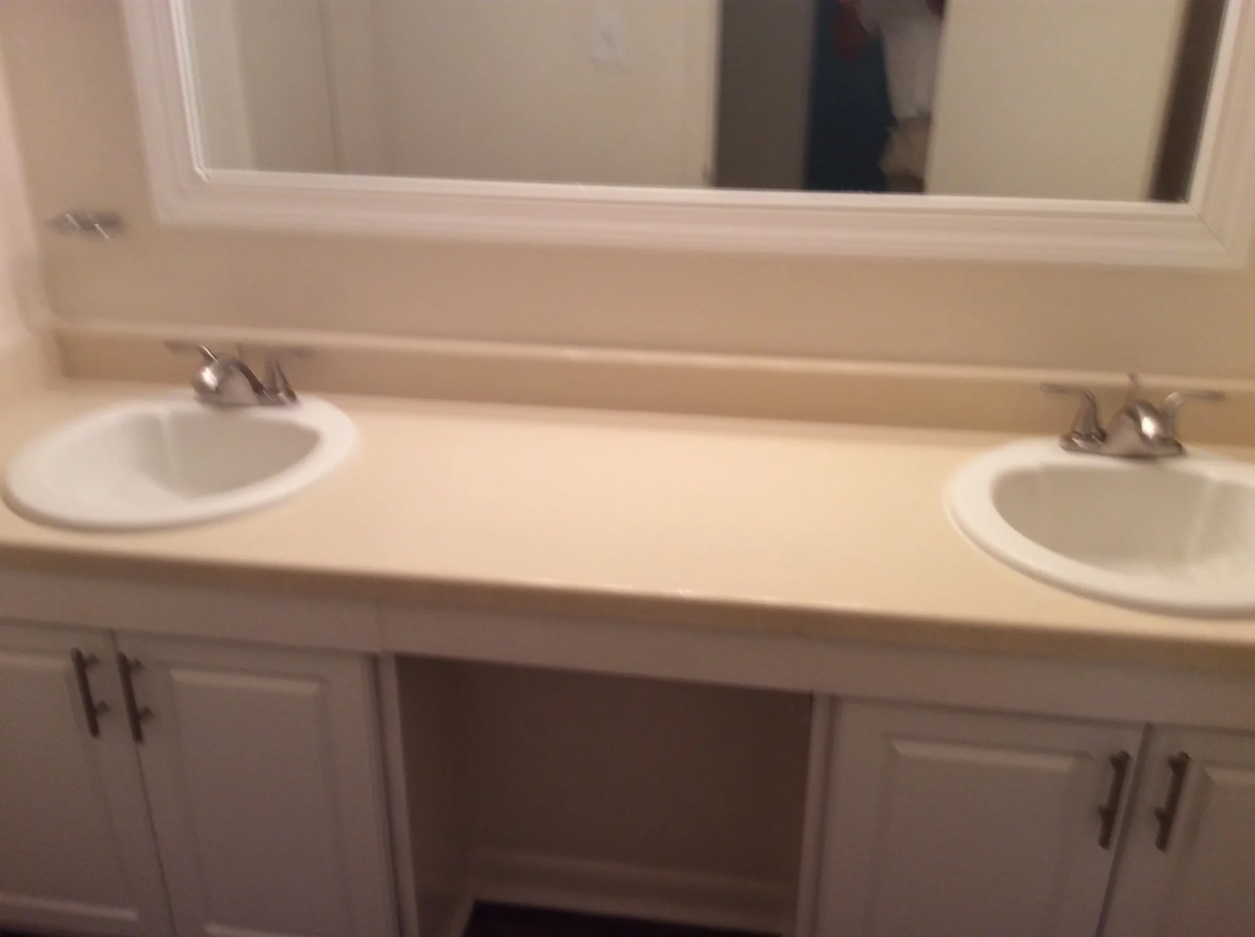 Double-sink apartment bathroom countertop before refinishing