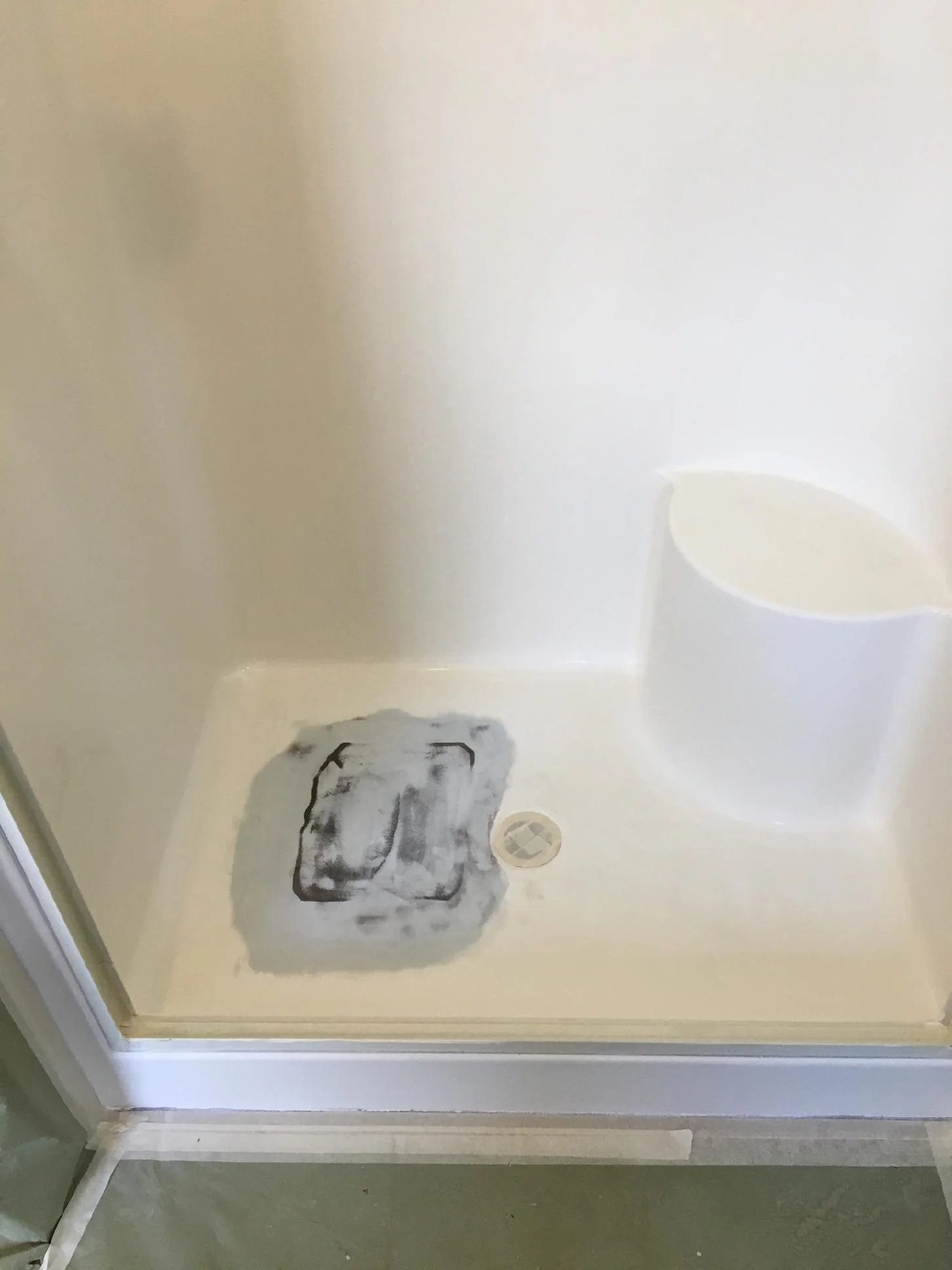 Damaged dormitory or apartment shower base before refinishing