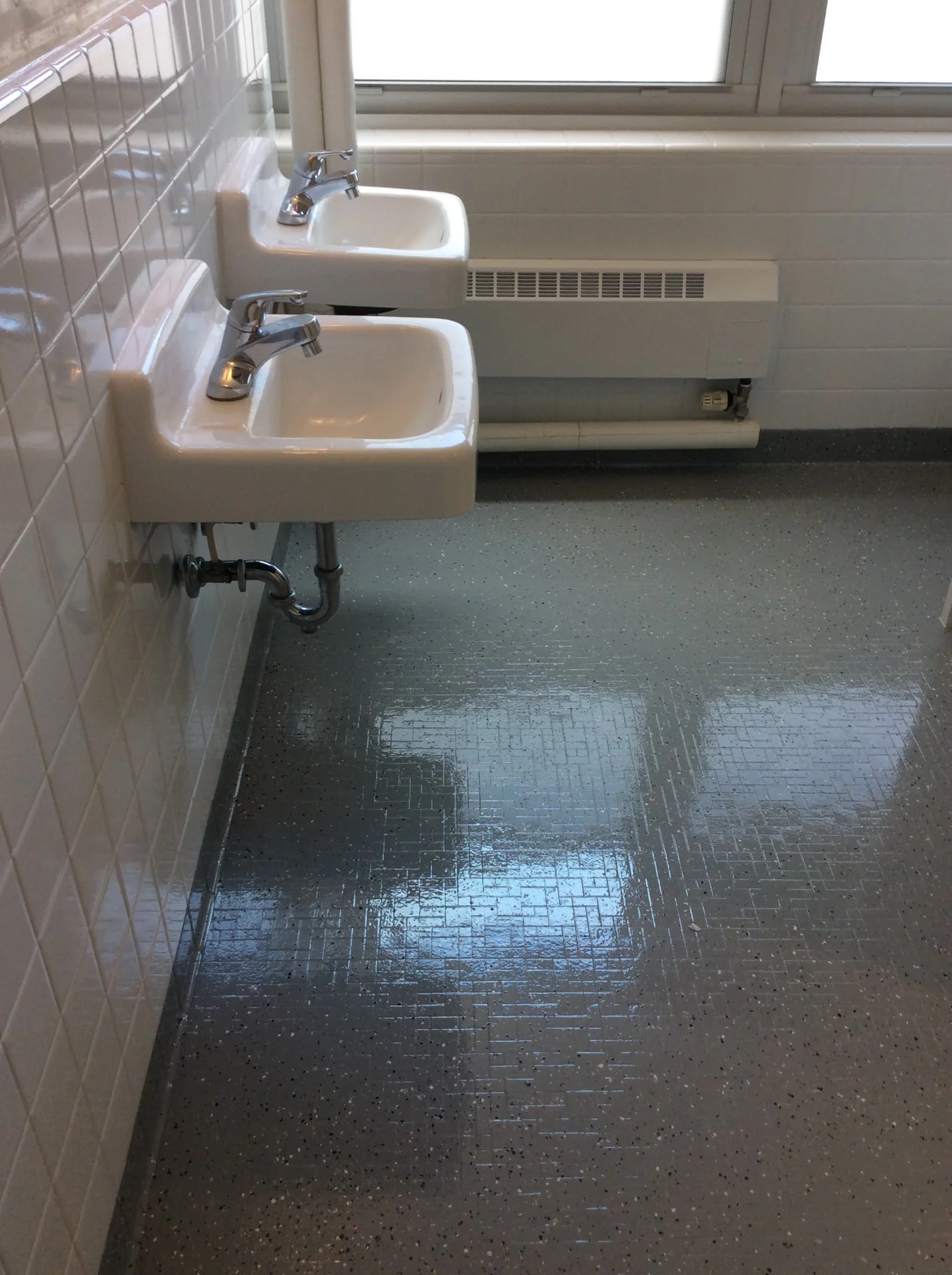 Dormitory sinks, tile walls, and floor after refinishing