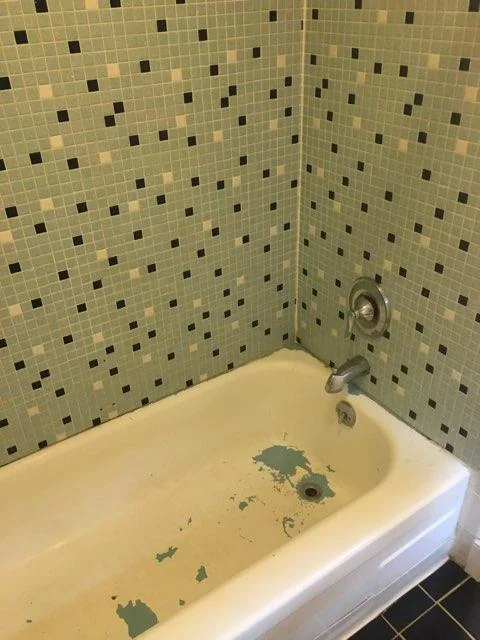 Worn hotel bathtub before commercial refinishing