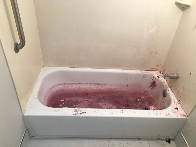 Heavily stained hotel bathtub before refinishing