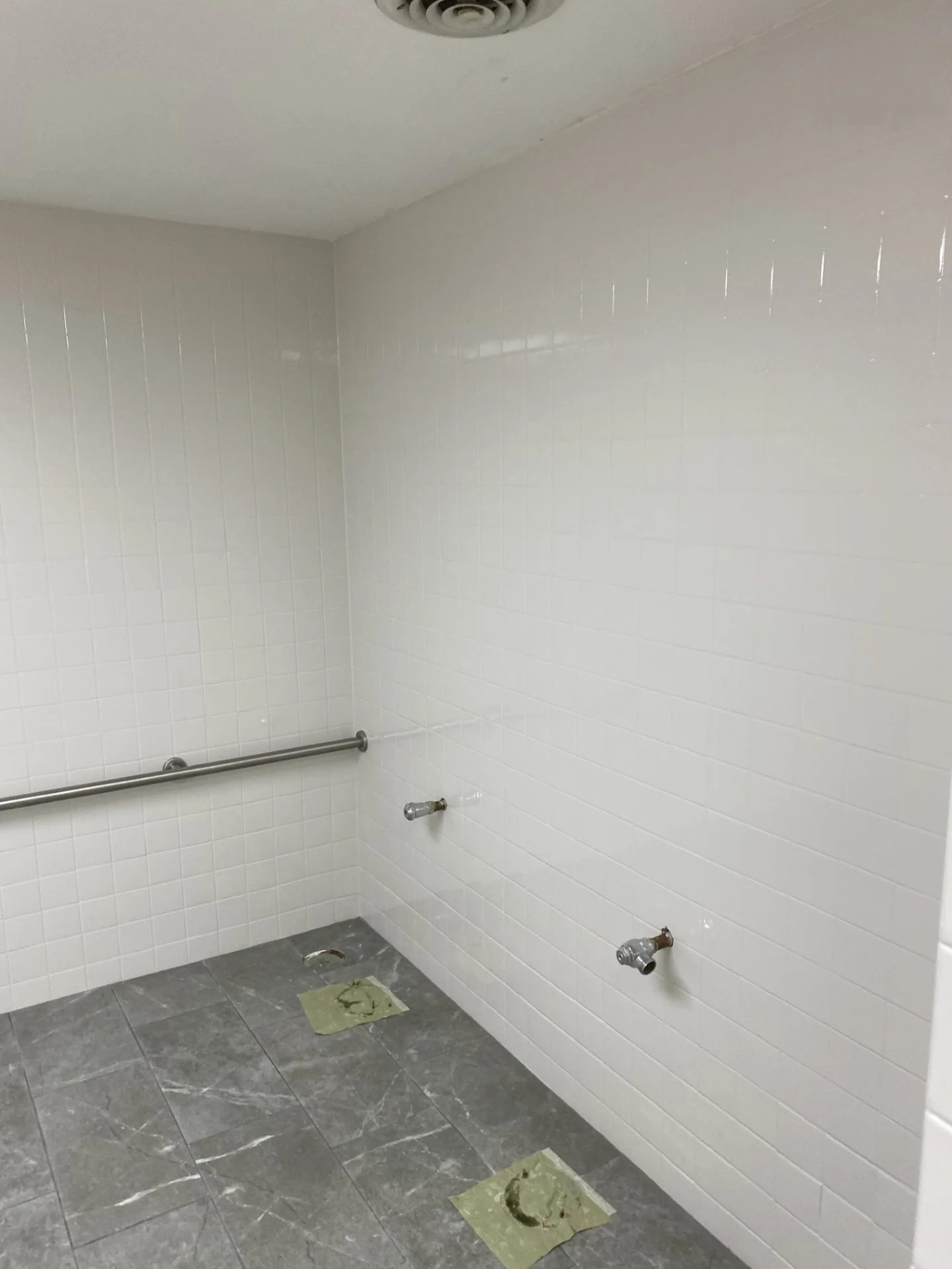 Bright refinished locker room shower tile