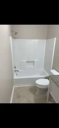 Bright restored bathtub and surround after refinishing
