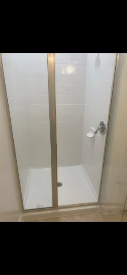 Bright white shower walls and base after refinishing