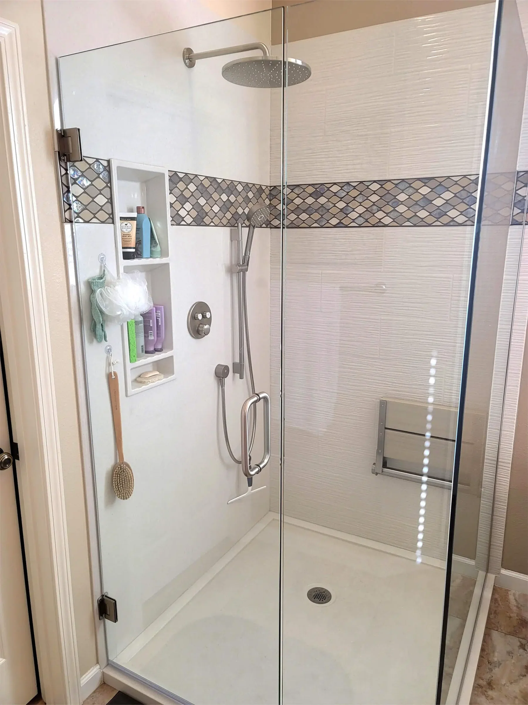Completed shower with accent wall pattern, niches, and glass enclosure